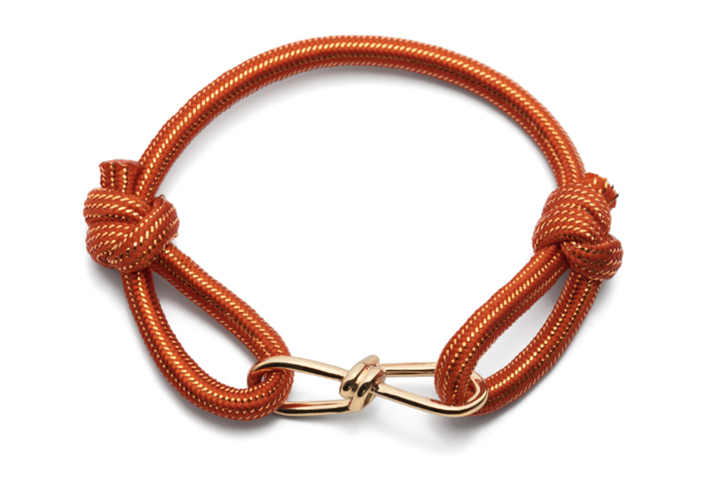 Orange braided rope bracelet with two knots and a gold-tone metal clasp.